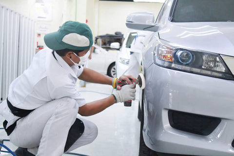 Person polishing car bumper using 12V Cordless Mini Polisher and Drill Driver Combo Kit With Three Inch Polisher, cordless tool in use