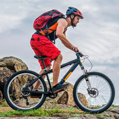 Cyclist on a mountain bike with lightweight aluminum front fork for mountain bikes with air suspension 26 inch for trail rides.