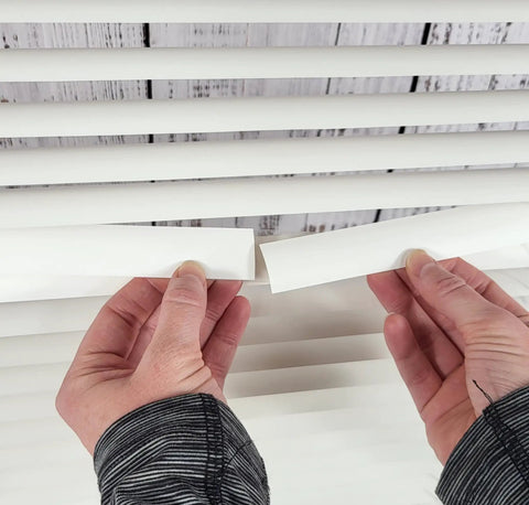 Easy DIY Slick Fix For Cracked Horizontal Blinds Clear Mini Slat Repair Kit With String Holes And Solid Tabs Restores Window Coverings Instantly with hands applying repair tabs.