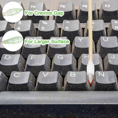 Cotton swab with bamboo stick, six-inch pointed tip, front view on a dusty keyboard for electronics cleaning