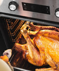 Oven with 2-Pack Universal Oven Control Knob Replacement For Air Fryer, Stove, And Grill, showing installed knobs and roasted turkey inside.