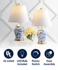 Pair of blue and white ceramic ginger jar table lamps with linen shades, 22 inch tall, on a white table, French country Chinoiserie style.