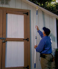 Person using Patented Carpenter Bee Traps For Outdoor Use With 304 Stainless Steel Mesh Seal And 30 Hole Filler Plugs on shed siding.