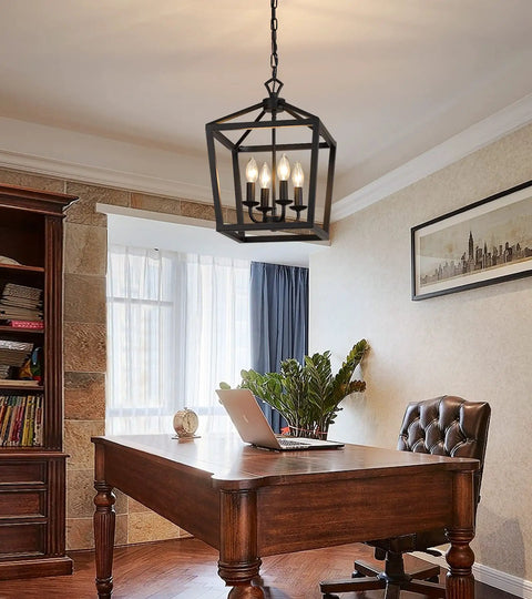 Farmhouse Rustic Black Lantern Chandelier Hanging Light Fixture With Four Lights For Kitchen Island And Dining Room Hallway Entryway Foyer UL Listed Dope Wrought Iron Vintage Industrial Lamp hanging over a wooden desk in an office.