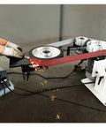 Heavy-Duty Shop Beast 71 Inch Belt Grinder in use, sparks flying, showing grinding action and vertical mode adjustment.