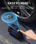 Portable Tire Inflator Air Compressor With Digital Pressure Gauge showing PSI, next to car tire on pavement