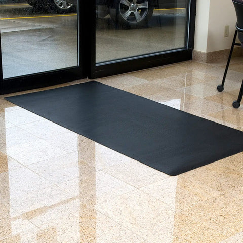 Indoor Outdoor Rubber Scraper Mat For High Traffic Areas 36 Inch By 6 Foot Black Heavy Duty Doormat on tiled floor by glass doors.