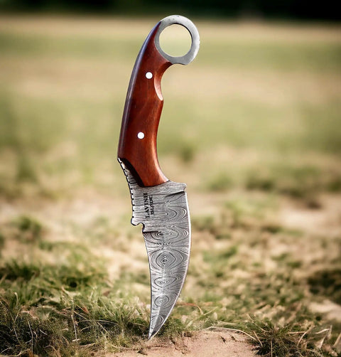 Handmade Damascus Steel Curved Fixed Blade Hunting Knife Nine Inch With Wooden Handle Ring Pommel Leather Sheath in grass