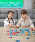 Children playing with World Map Wooden Puzzle For Kids Ages 4 To 6: Learn Continents And Oceans with landmarks on a table