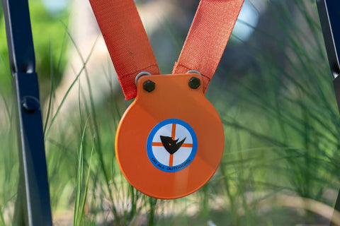 Close-up of Mini Gong Steel Shooting Target For.22 caliber with stand in the grass, showing durable powder coated steel plate.