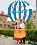 Family posing with Epic 78 Inch Hot Air Balloon Photo Booth Frame Travel Theme Selfie Prop Great For Kids Birthday Parties