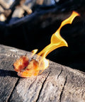 Pyro Putty Emergency Fire Starter For All Seasons Eco Blend Waterproof And Windproof 2 Oz Can burning on log outdoors
