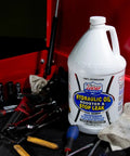 Hydraulic Oil Booster and Stop Leak Additive for Leaky Seals, Wet Brakes and Varnish Build Up, 1 Gallon bottle on workbench