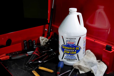 Hydraulic Oil Booster and Stop Leak Additive for Leaky Seals, Wet Brakes and Varnish Build Up, 1 Gallon bottle on workbench