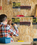 Person installing Wall Mounted Screwdriver Organizer Rack, Heavy Duty Steel Tool Holder With 28 Tool Capacity in a workshop