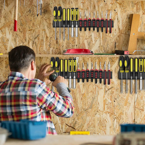 Person installing Wall Mounted Screwdriver Organizer Rack, Heavy Duty Steel Tool Holder With 28 Tool Capacity in a workshop