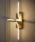 9-Inch Gold Modern Minimalist Integrated LED Vanity Light Sconce Dope Glow Dimmable Metal Wall Lamp illuminated against a wall