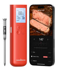 Red Smart Bluetooth Wireless Meat Thermometer With Standalone Display Base No App Required next to smartphone showing steak cooking