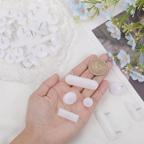 125 Piece White Tack In Drawer Glides Heavy Duty Furniture Slider Repair Kit For Dressers Solid Plastic And Iron Construction with a coin for size reference.