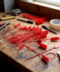 1000 Pack Plastic Tamper-Evident Security Seals With Self-Locking Pull-Tight Zip Ties, 2026 Numbered Red Tags For Fire Extinguishers, Disposable 250 mm Length on a workbench