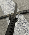 Close-up of Dope Six Color Iaido Training Katana Set With 1060 Carbon Steel Blades, black handle on patterned cloth