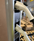 Close-up of Level 2 Dual Port 240V 30A Wall Mount EV Charger For Home Or Business with dual charging cables attached.