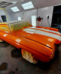 Showroom Smooth Dreamsicle Orange Basecoat Paint Gallon Ready To Spray Mix With Slow Reducer For Zero Hassle Street Car Restorations And Bumper To Bumper Shine on a prepped car in a spray booth.