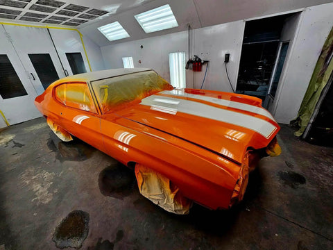Showroom Smooth Dreamsicle Orange Basecoat Paint Gallon Ready To Spray Mix With Slow Reducer For Zero Hassle Street Car Restorations And Bumper To Bumper Shine on a prepped car in a spray booth.