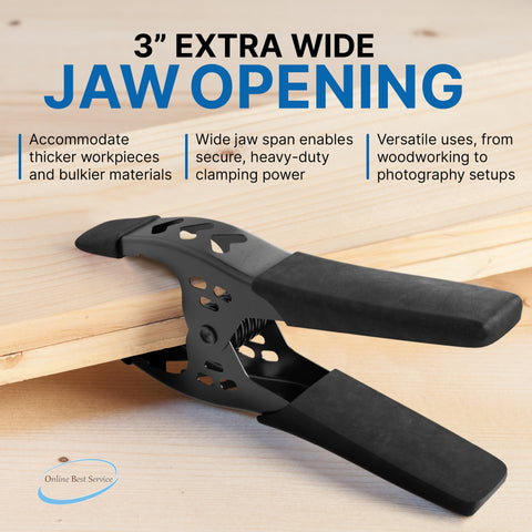 Close-up of a black 6 inch heavy duty metal spring clamp with extra wide 3 inch jaw opening gripping a wooden board