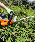 Electric Hedge Trimmer With Corded Power, 4.8 Amp, 24 Inch Dual Action Laser Blade used on lush green bushes