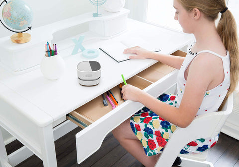 Cordless Desk Vac For Quick Cleanup, Tiny Table Dust Sweeper on girl's desk with 360 degree rotating nozzle in home setting, white.