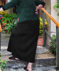 Elderly woman using Sturdy Metal Wood Grain Handrail For 3 Step Outdoor Stairs for support while ascending steps.