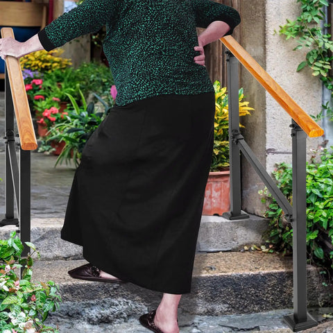 Elderly woman using Sturdy Metal Wood Grain Handrail For 3 Step Outdoor Stairs for support while ascending steps.