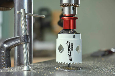Close-up of a 13 Piece Hole Saw Set with Quick Change Arbor and Quickcore Technology for Up to 10X Faster Core Ejection in use