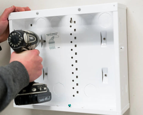 12 Inch Cable Management In Wall Media Box For Home Networking Setup With 2.5 Inch Wire Openings Structured Wiring Enclosure In Glossy White EN1200 Being Installed