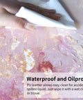 Big Ol Pink Desk Pad, 31.5 By 15.7 Inch, Rose Gold Marble, PU Leather shown being wiped clean to demonstrate waterproof feature.