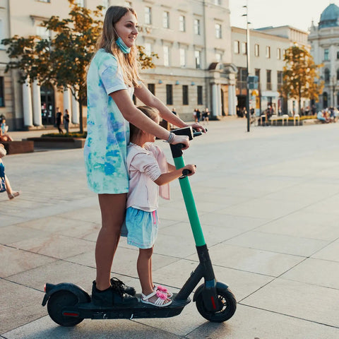 Parent and child riding electric scooter with Kiddo Height Adjustable Electric Scooter Handlebar Grip Bar For Safe Rides And Easy Hold Aluminum Alloy Armrest Handle Lightweight Durable Design Fits Xiaomi M365 Mijia Electric Scooters And Skateboards on open plaza