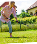 Woman using Beefy Heavy Duty Manure Fork for Farm and Garden, Lightweight Iron Pitch Fork in yard cleanup