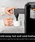 Person using fold-away frother on Hot And Cold Brew System With Thermal Carafe All In One Coffee And Tea Maker, Black.