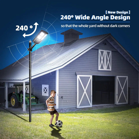 Ultra Bright Outdoor Solar Street Light With Dusk To Dawn Sensor illuminating a yard with 240° angle near a gray barn building.