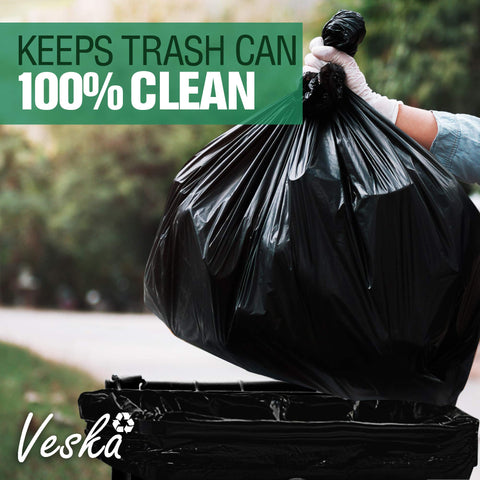 Heavy Duty Sixty Four Gallon Trash Bags Black Garbage Containers Value Pack Of Fifty With Secure Tie Tops being lifted over a clean trash can.
