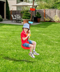 Child playing on rope ladder and disc swing set for kids, durable climbing ladder for swing sets, backyard fun, green lawn