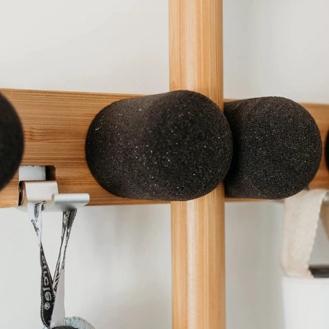 Close-up of Get A Grip Wall Mounted Mop And Broom Organizer Made Of Lightweight Bamboo With Foam Pegs installed on a wall.