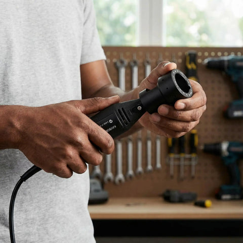 Man holding Tungsten Electrode Grinder Sharpener For TIG Welding with aluminum head in workshop setting.