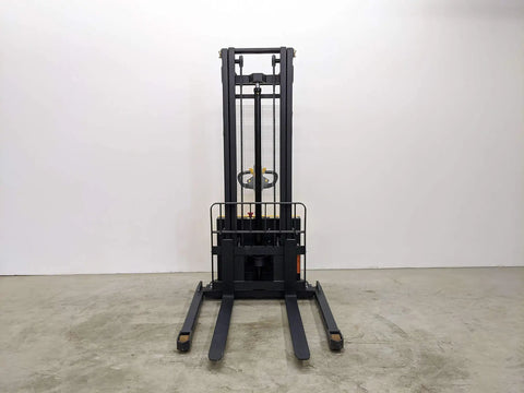 Built Tough Electric Wide Leg Pallet Stacker Heavy Lifter With 2204 Lbs Capacity And 130 Inch Lift Featuring Maintenance Free Battery 110V Us Plug Speed Control And Three Year Warranty Yellow front view on concrete floor.