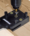 Close-up of Handheld Dowel Jig For Flawless Corner Edge Surface Woodworking Joints With Adjustable Fence in use.