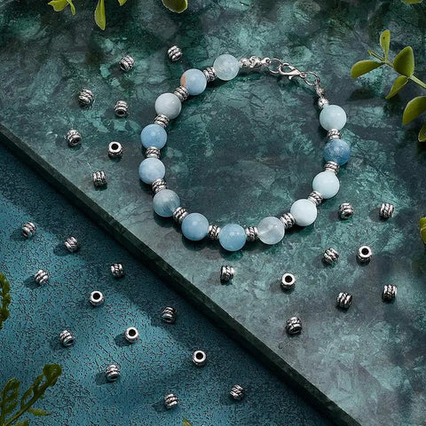 Antique Silver Tube Spacer Beads 300 Pcs Tibetan Zinc Alloy 4x5mm With 2.2mm Hole for bracelet jewelry making on blue background