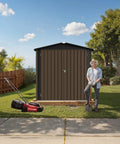 Man standing beside 6 By 4 Outdoor Storage Shed In Brown Sturdy Metal Building With Floor Frame And Operable Window Perfect Tool Shed For Garden Backyard Poolside Or Lawn Weatherproof Ventilated Storage For Tools And Gear