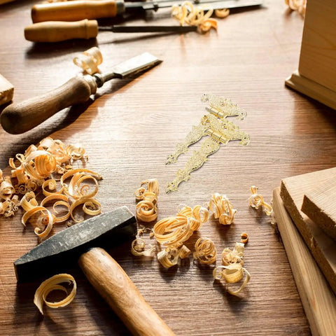 Vintage Zinc Alloy Box Hinges For Furniture And Flower Boxes with wood shavings and tools on a workbench