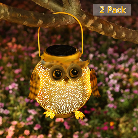 Two Pack Hanging Solar Lanterns With Owl Pattern glowing at night in garden, metal owl-shaped outdoor light on tree branch